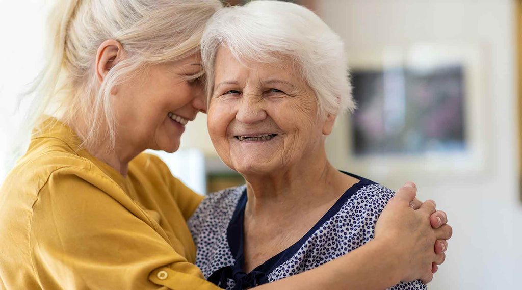 Daughter hugging Elderly Woman with Dementia