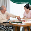 Senior doing birdfeeder jigsaw puzzle with dementia nurse