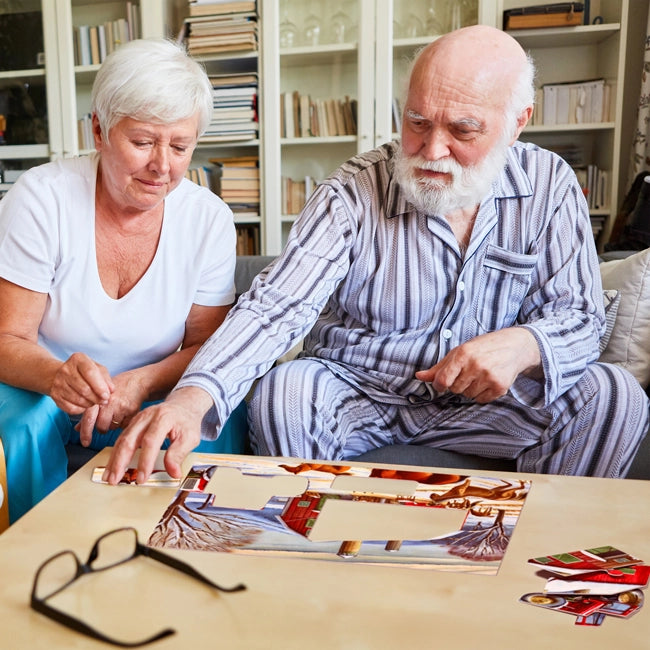 seniors with dementia doing jigsaw puzzle for Alzheimer's patients in memory care