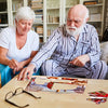 seniors with dementia doing jigsaw puzzle for Alzheimer's patients in memory care