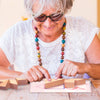 Senior playing with Classic Tangram Teasers Puzzle Box