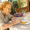 elderly woman with dementia doing simple origami from keeping busy